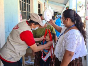 Guatemala, Hurricane Response, Medical Teams staff measure baby's weight at shelters where families are staying